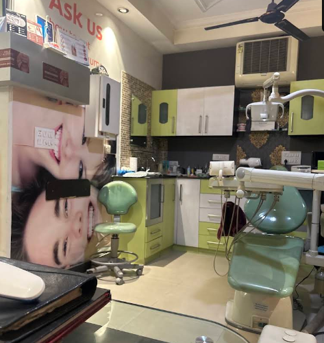 Treatment room at The Smile Lounge with a mint green dental chair and green cabinets